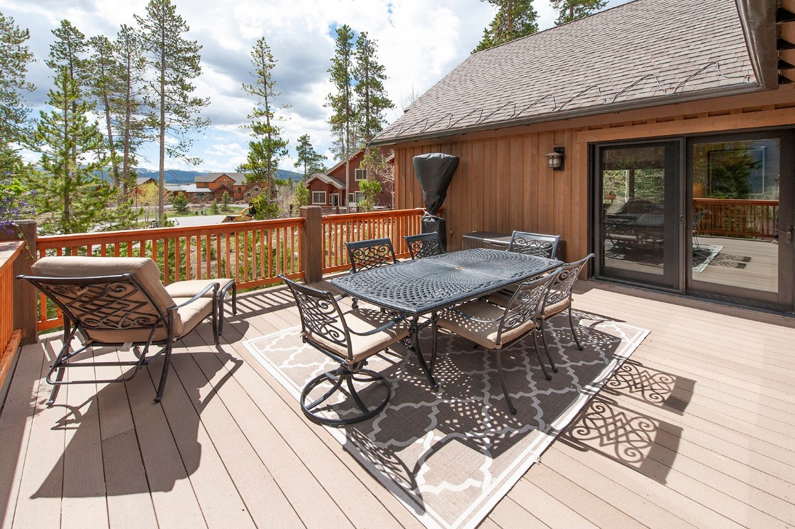 724 Willowbrook Road Silverthorne, CO 80498 - Photo 5 of 30 a view of a roof deck with table and chairs a barbeque with wooden floor and fence