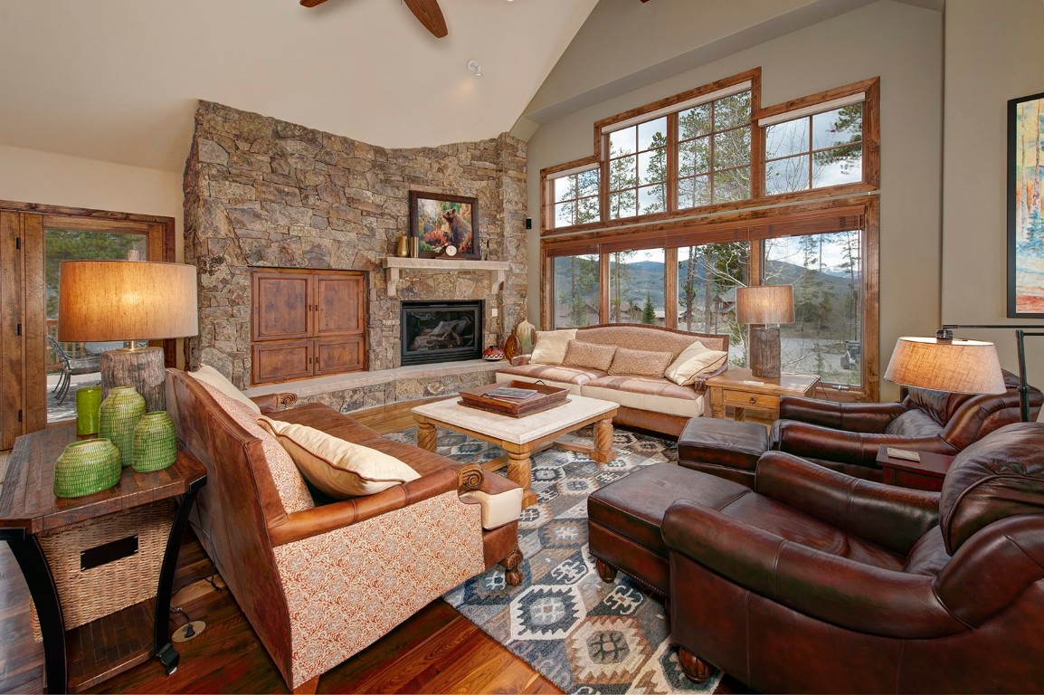 724 Willowbrook Road Silverthorne, CO 80498 - Photo 6 of 30 a living room with furniture a fireplace and a floor to ceiling window