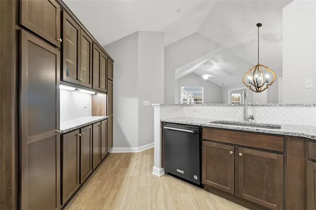 a kitchen with stainless steel appliances granite countertop a sink and stove