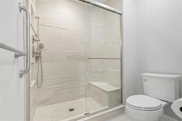 a bathroom with a shower and a toilet