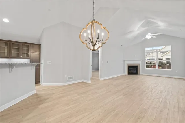a view of empty room with wooden floor and fireplace