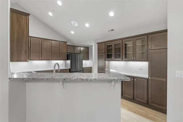 a kitchen with stainless steel appliances granite countertop a sink and a granite counter tops