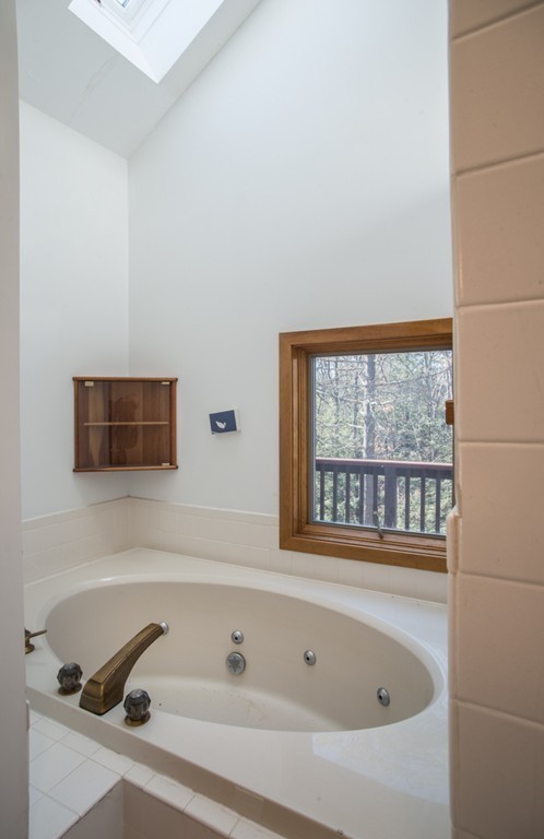 61 South Valley Road Amherst, MA 01002 - Photo 24 of 38 a bathroom with a bathtub and a window