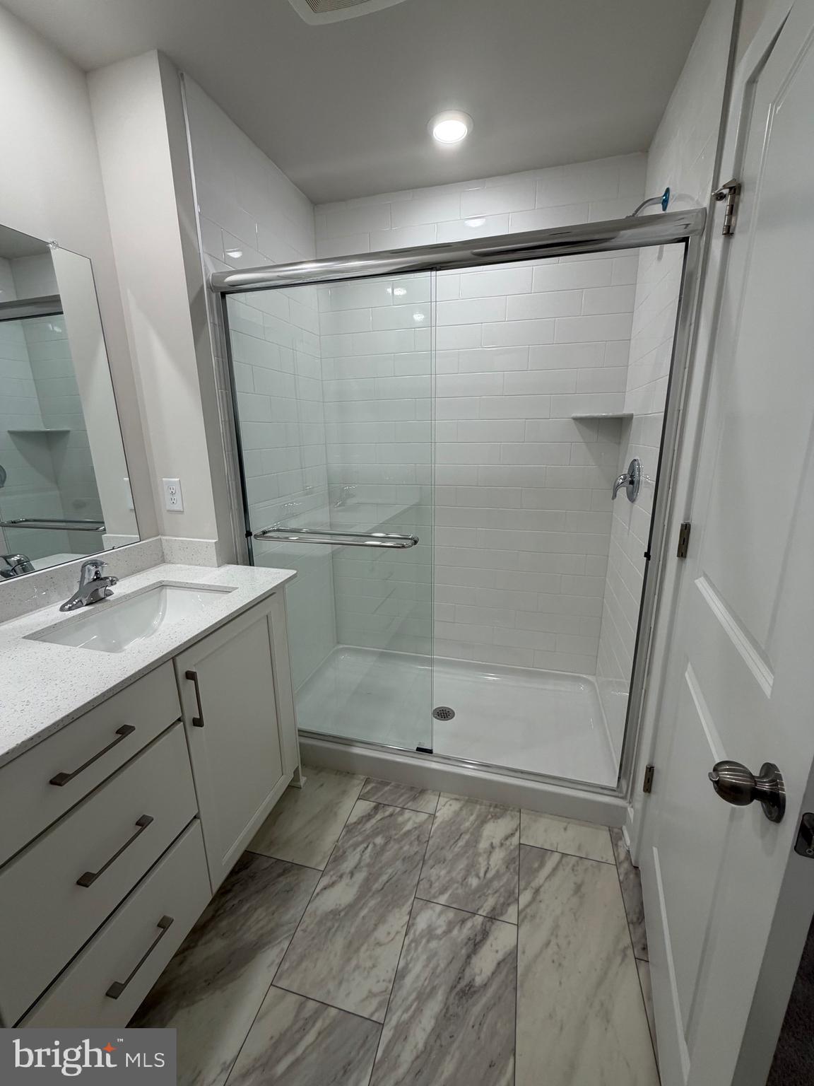 10 Barbine Way Bridgeport, PA 19405 - Photo 17 of 44 a bathroom with a shower sink and mirror