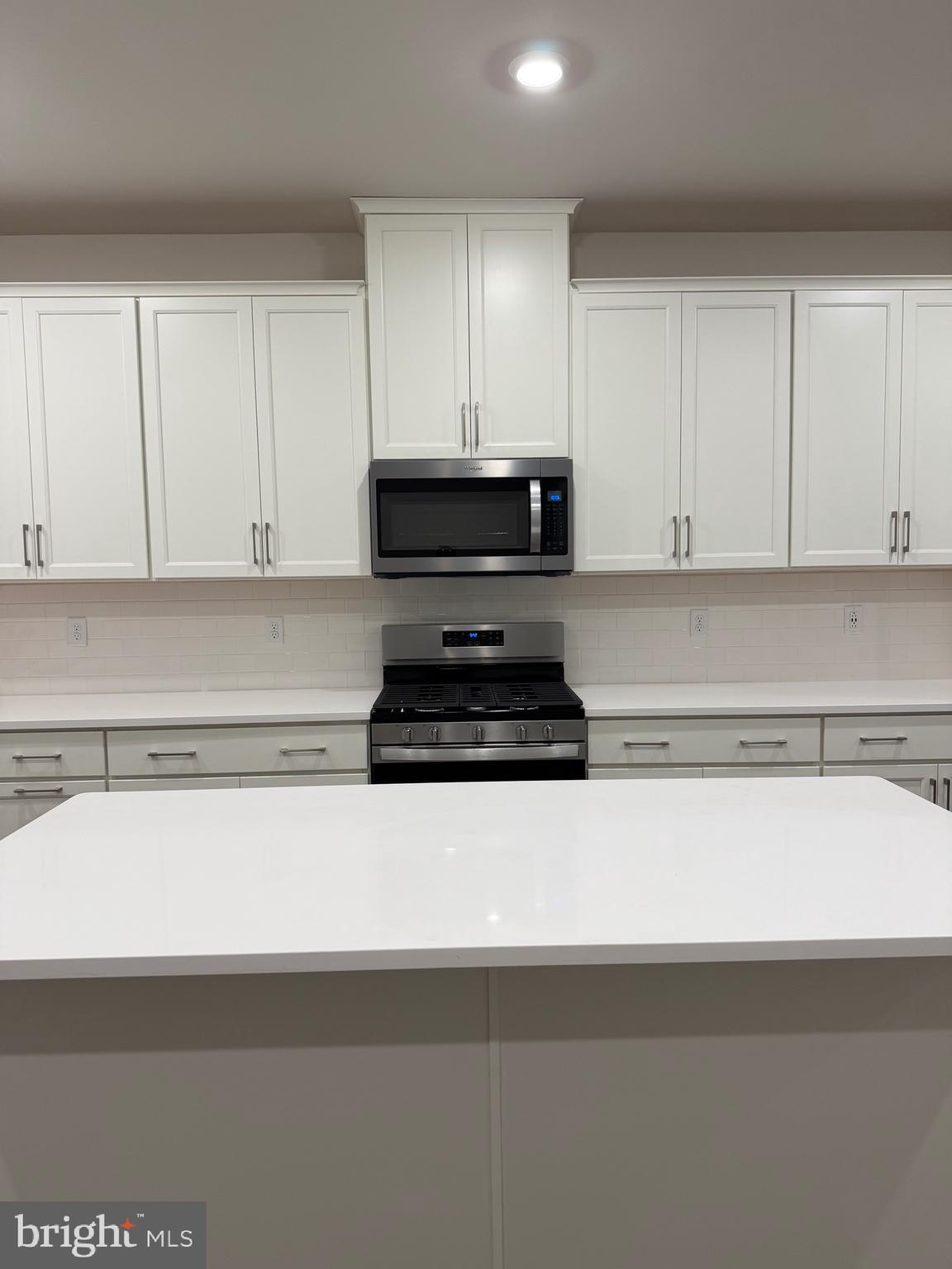 10 Barbine Way Bridgeport, PA 19405 - Photo 41 of 44 a kitchen with granite countertop white cabinets and black appliances