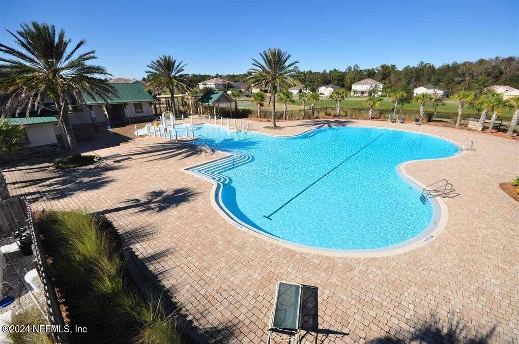 1108 Nochaway Drive St. Augustine, FL 32092 - Photo 2 of 11 a view of a swimming pool with an outdoor space and seating area
