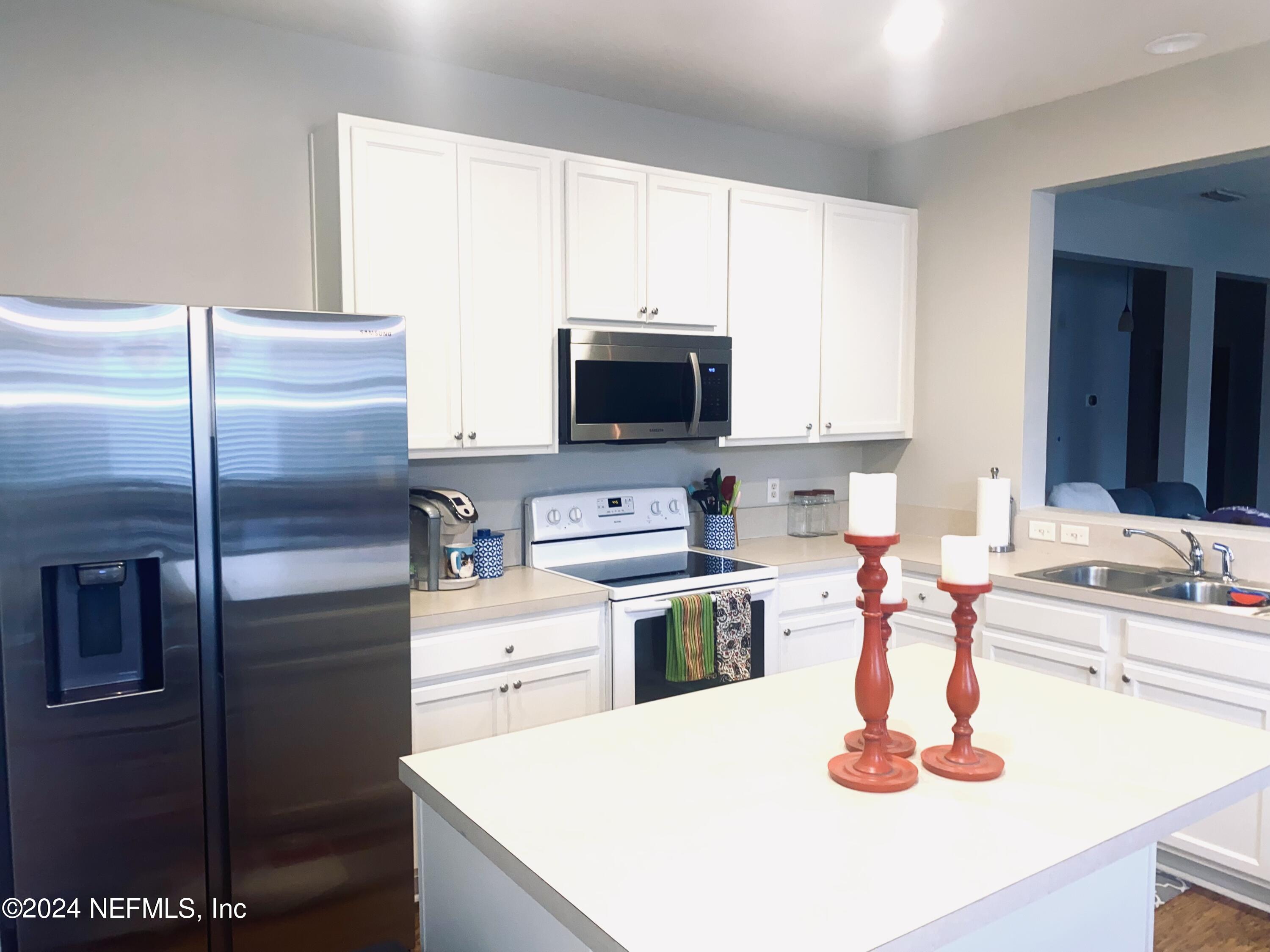 1108 Nochaway Drive St. Augustine, FL 32092 - Photo 6 of 11 a kitchen with a refrigerator and a sink
