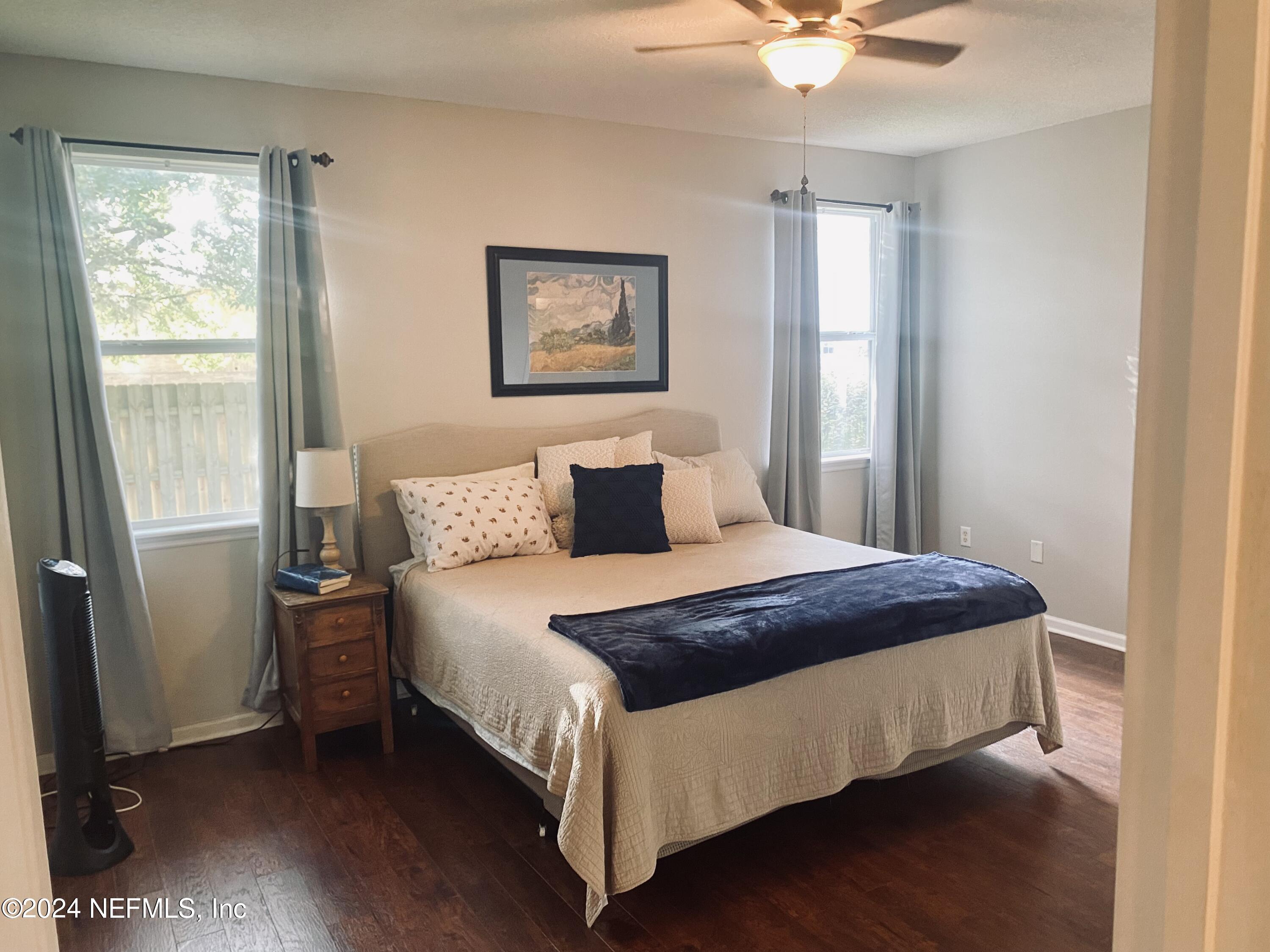 1108 Nochaway Drive St. Augustine, FL 32092 - Photo 8 of 11 a bedroom with a bed paintings on the wall and a window
