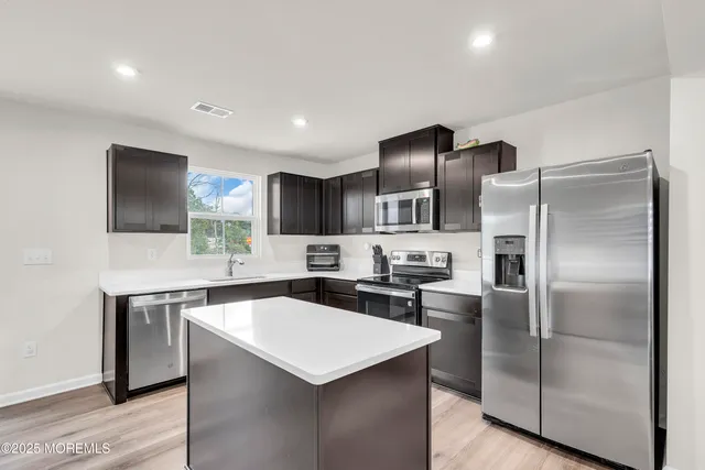 a kitchen with a refrigerator sink and microwave