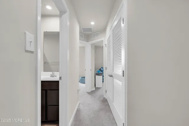 a view of a hallway with wooden shelves