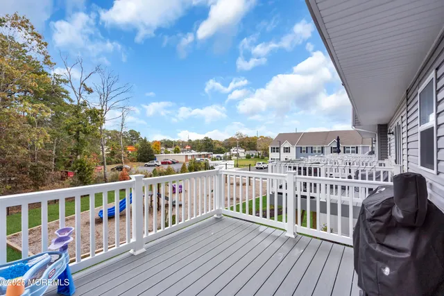 a view of a balcony with wooden floor
