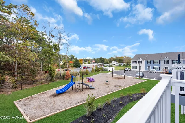 a view of yard with swimming pool and seating