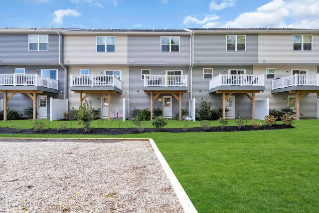 front view of a brick house with a yard