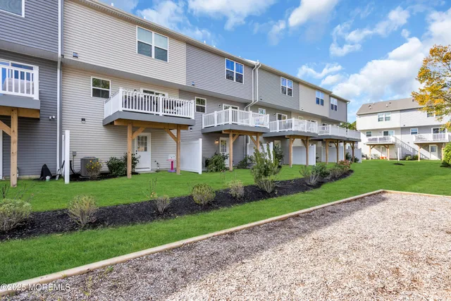 a front view of a building with a garden