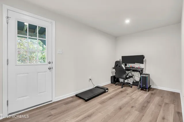 a view of workspace with wooden floor and gym equipment