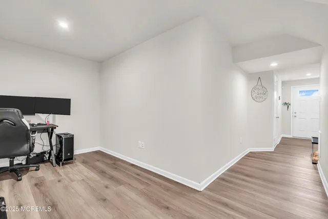 a view of workspace with wooden floor and lounge chair