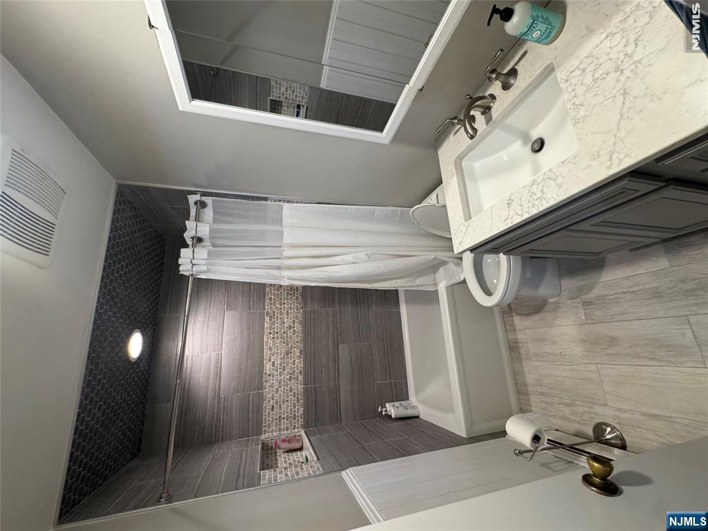 55 Maryann Road Oak Ridge, NJ 07438 - Photo 6 of 20 a bathroom with a granite countertop sink toilet and shower
