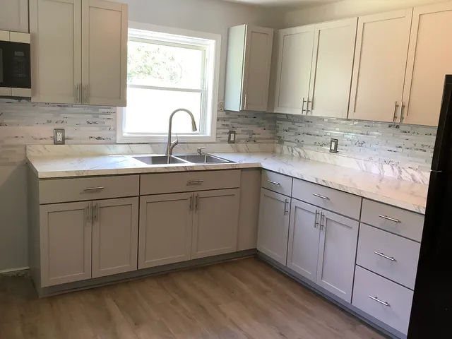 a kitchen with a sink cabinets and window