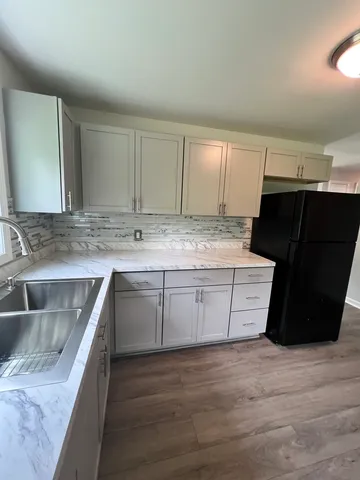 a kitchen with a sink stove and cabinets
