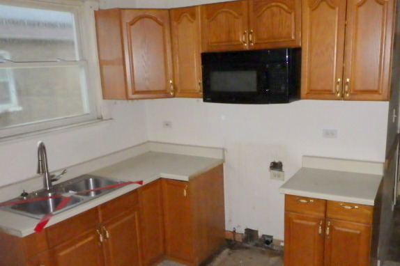 524 East 90th Street Chicago, IL 60619 - Photo 6 of 15 a kitchen with a sink and a microwave