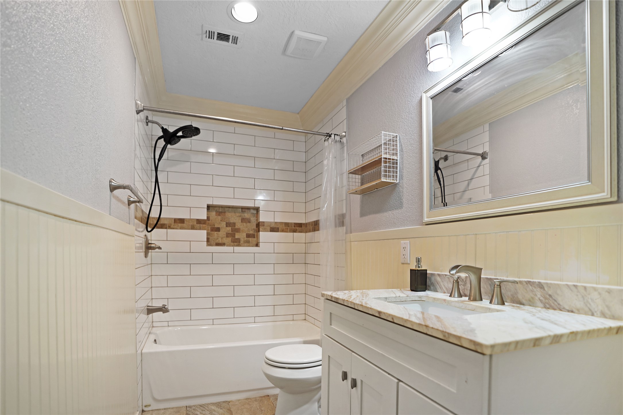 17119 Mellow Ridge Drive Spring, TX 77379 - Photo 22 of 32 This bathroom features a modern design with a tiled shower and tub combo, a stylish vanity with a marble countertop, and a large mirror. The neutral color palette and ample lighting create a bright, inviting space.
