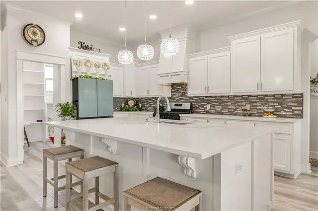 a kitchen with stainless steel appliances granite countertop a sink and cabinets