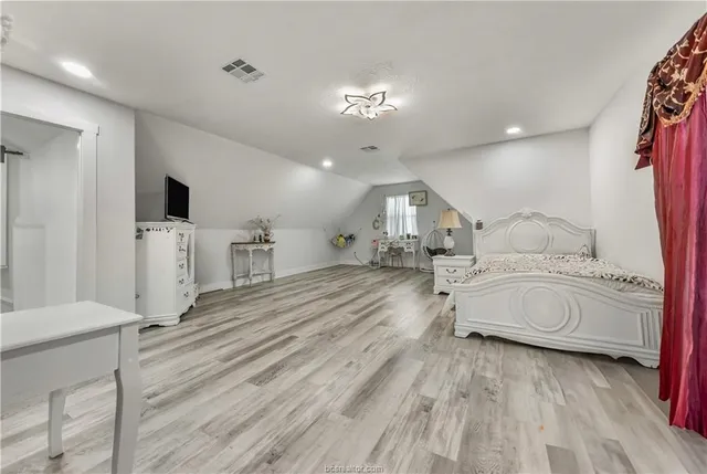 a spacious bedroom with a bed and a view living room
