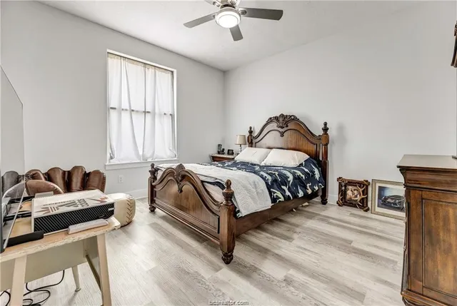 a bedroom with a bed and wooden floor