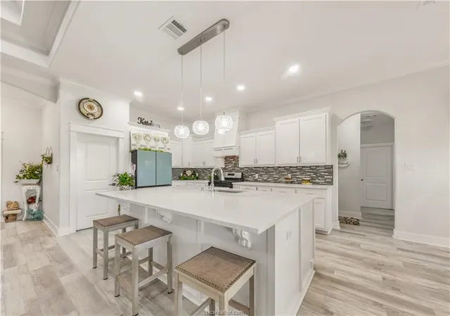 a large kitchen with a table and chairs