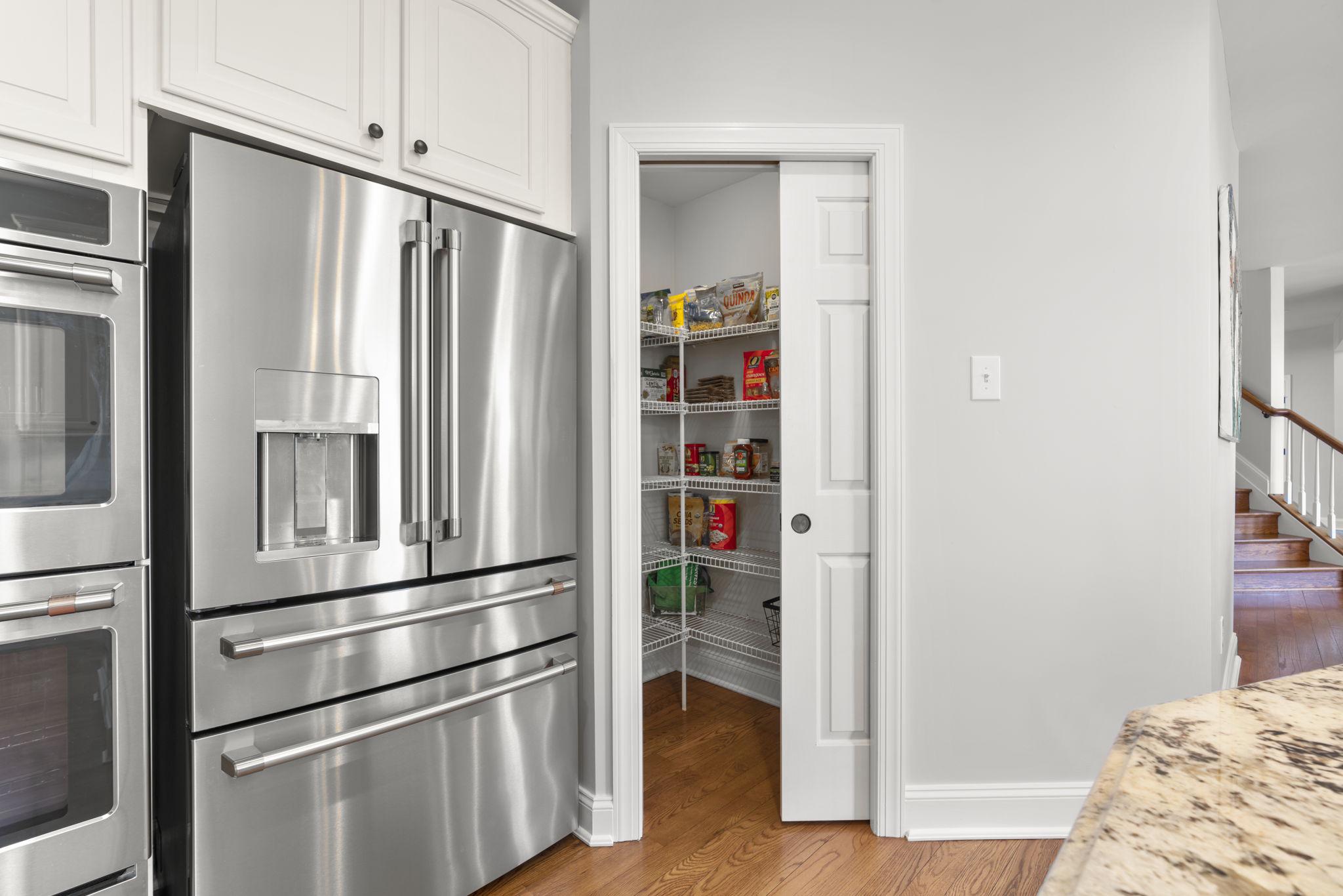 3088 Ballesteras Court Mount Airy, MD 21771 - Photo 12 of 64 a kitchen with stainless steel appliances a refrigerator and wooden floor