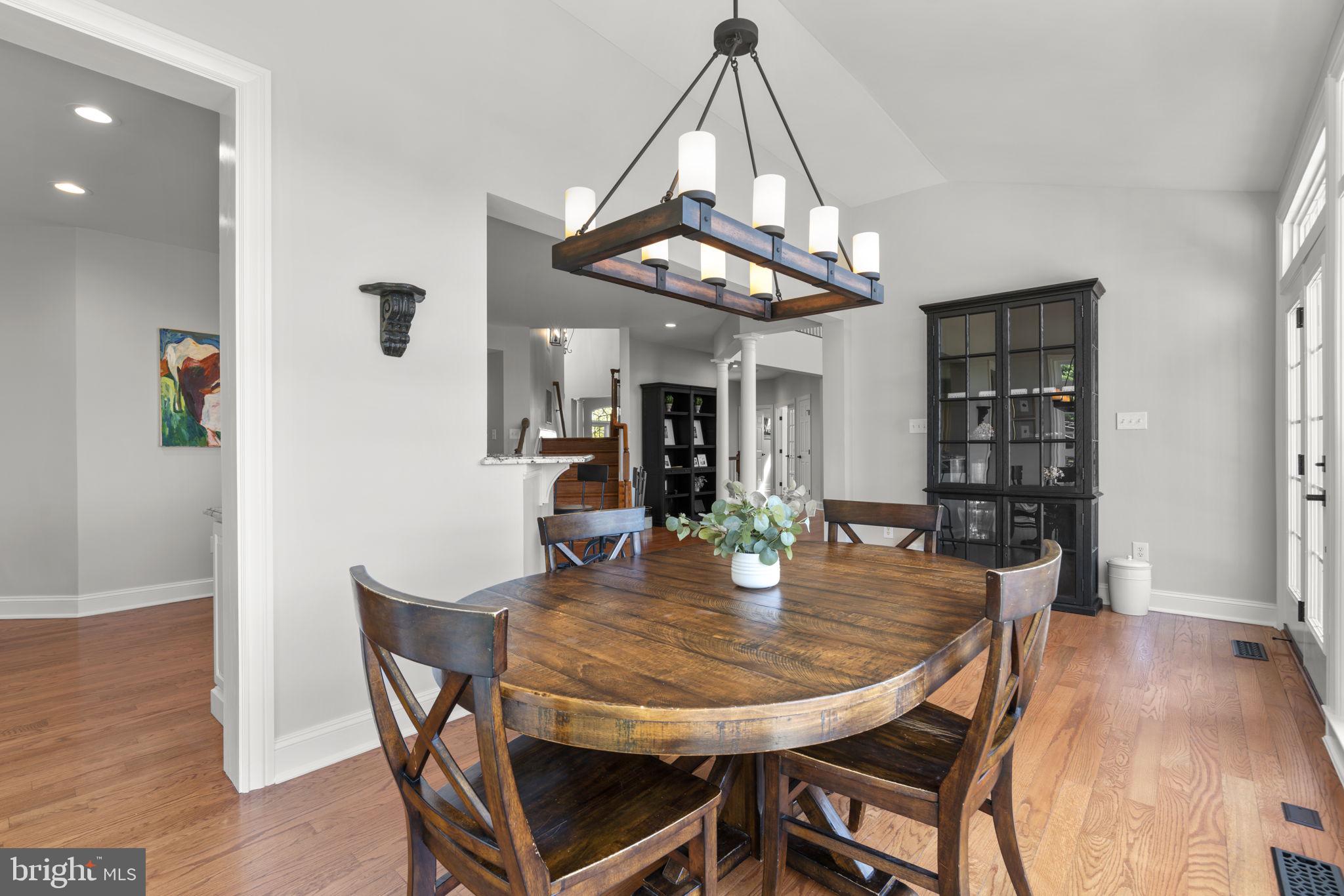 3088 Ballesteras Court Mount Airy, MD 21771 - Photo 15 of 64 a view of a dining room with furniture and wooden floor