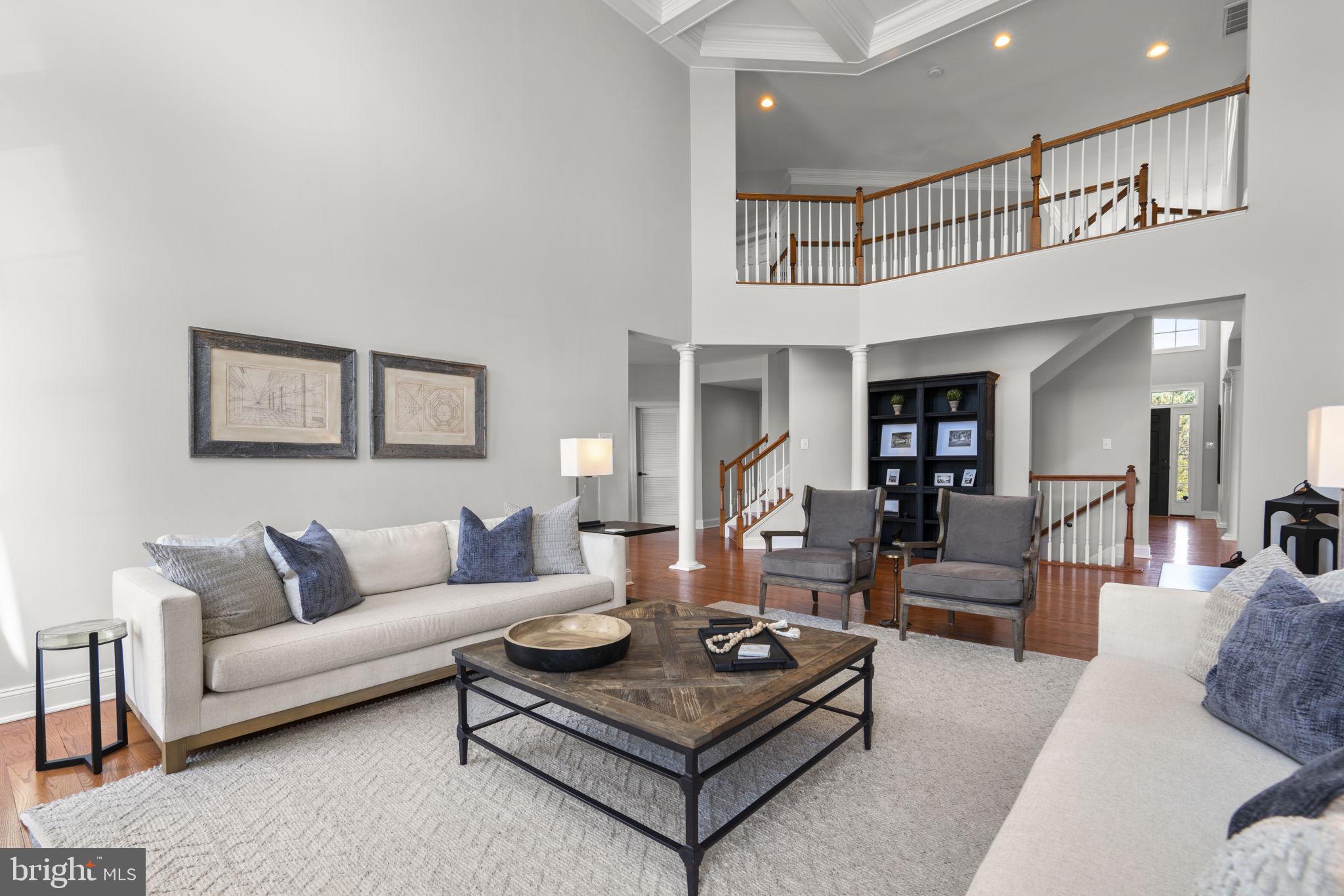 3088 Ballesteras Court Mount Airy, MD 21771 - Photo 20 of 64 a living room with furniture a rug and a wall painting