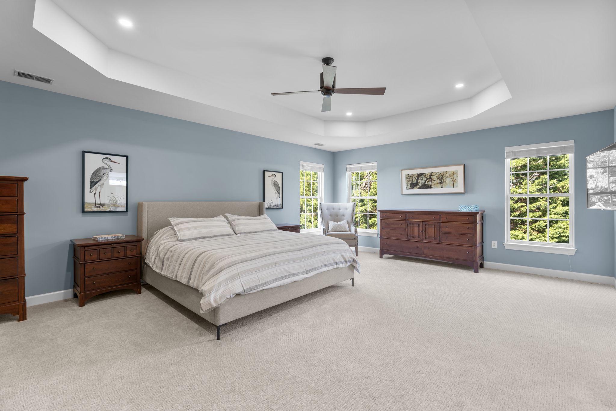 3088 Ballesteras Court Mount Airy, MD 21771 - Photo 25 of 64 a spacious bedroom with a bed and a chandelier