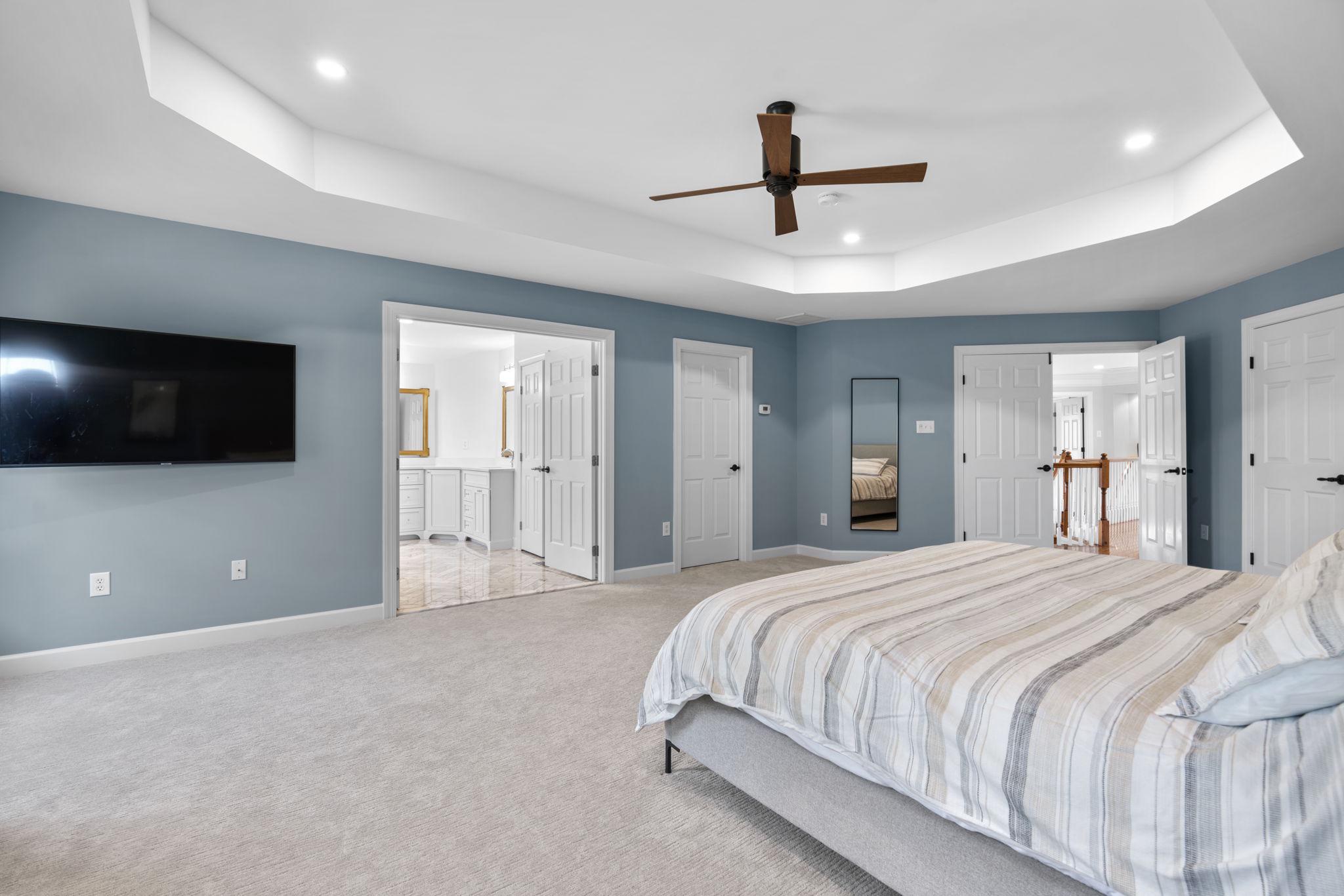 3088 Ballesteras Court Mount Airy, MD 21771 - Photo 27 of 64 a spacious bedroom with a bed and a flat screen tv