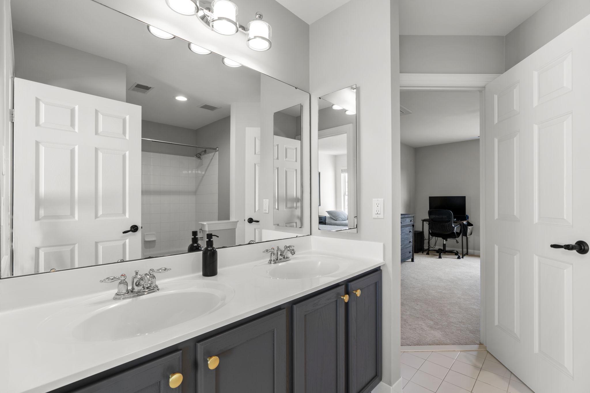 3088 Ballesteras Court Mount Airy, MD 21771 - Photo 37 of 64 a bathroom with a sink double vanity and a mirror