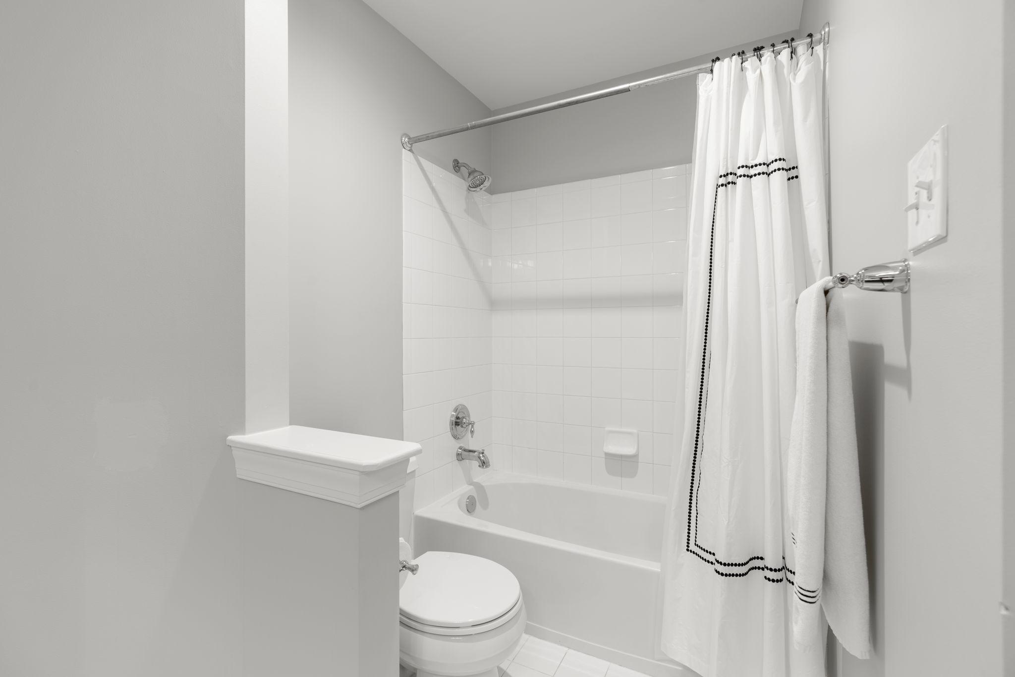 3088 Ballesteras Court Mount Airy, MD 21771 - Photo 38 of 64 a bathroom with a shower a toilet and a tub