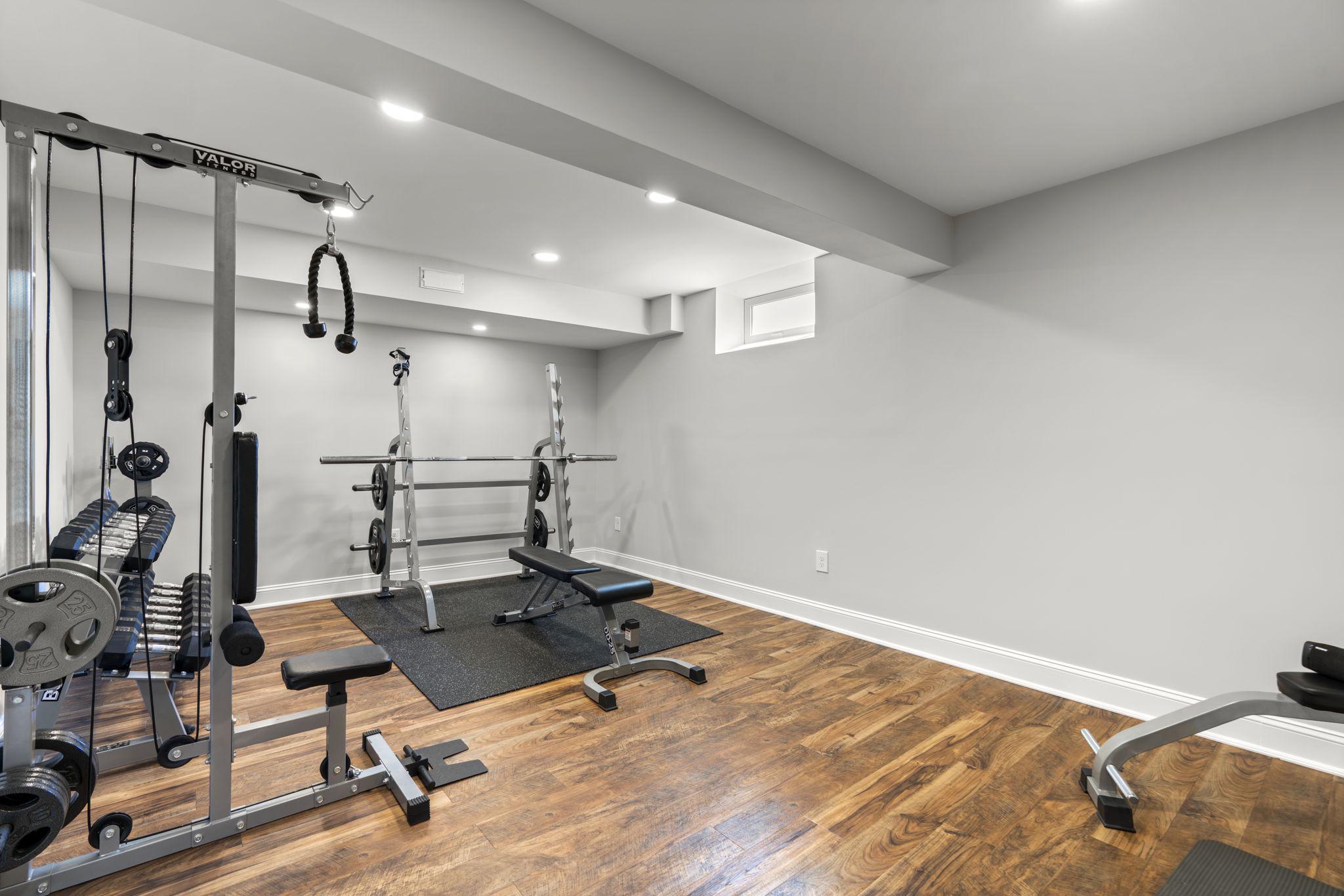 3088 Ballesteras Court Mount Airy, MD 21771 - Photo 48 of 64 a room with gym equipment and wooden floor