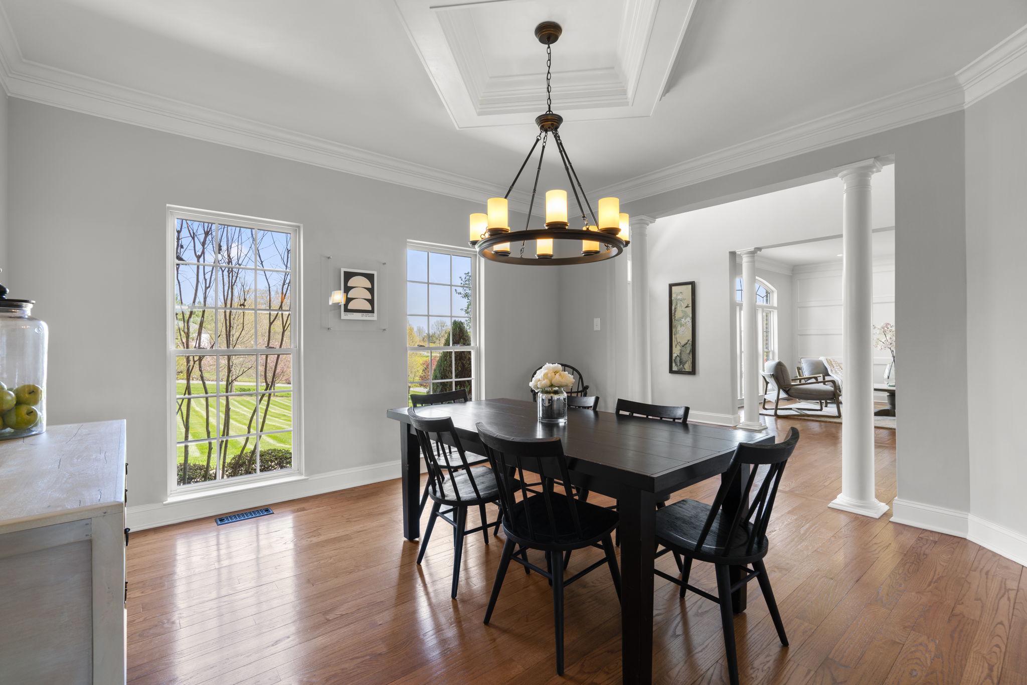 3088 Ballesteras Court Mount Airy, MD 21771 - Photo 7 of 64 a dining room with wooden floor a chandelier a wooden table and chairs