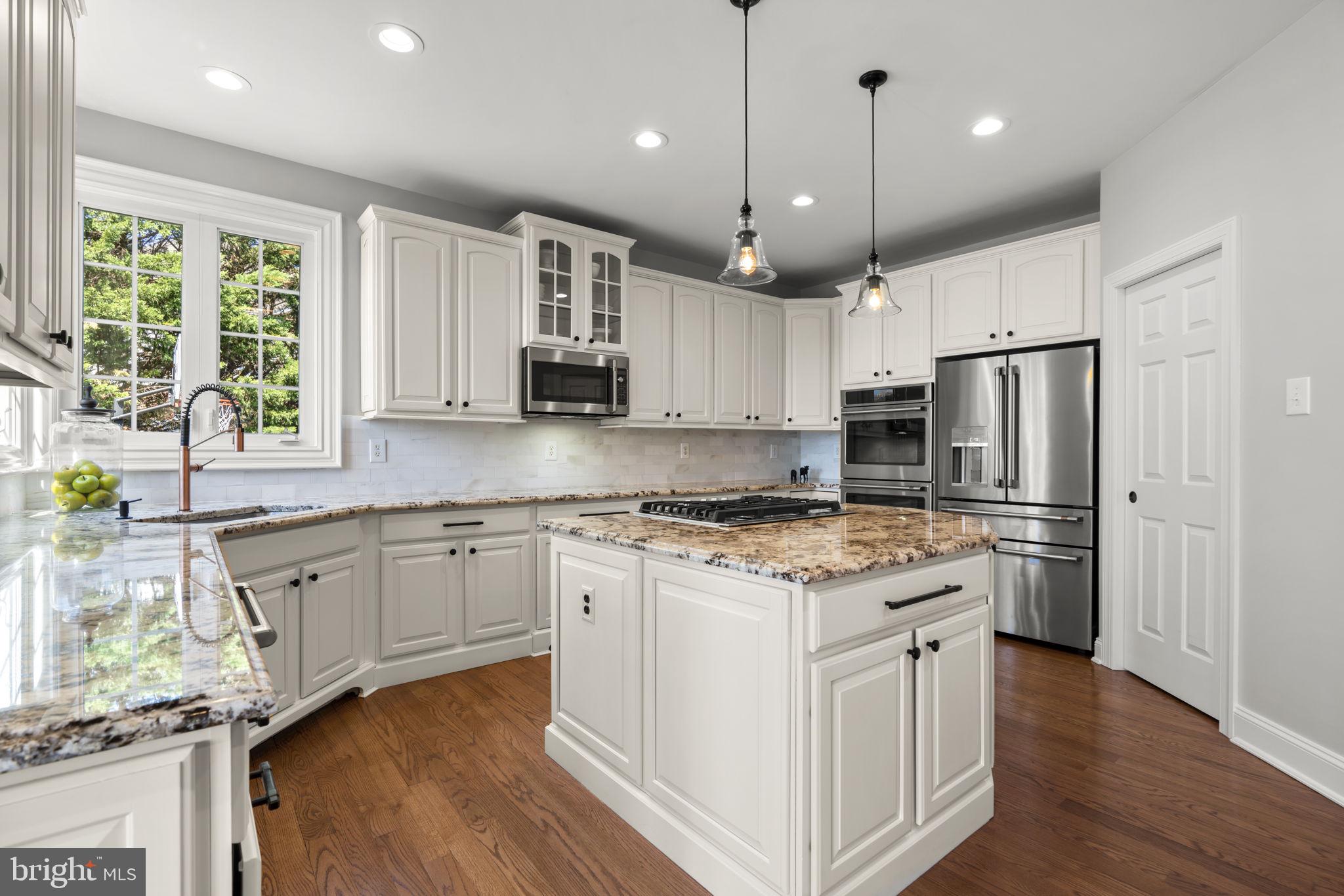 3088 Ballesteras Court Mount Airy, MD 21771 - Photo 10 of 64 a kitchen with stainless steel appliances granite countertop a refrigerator a stove a sink and a microwave