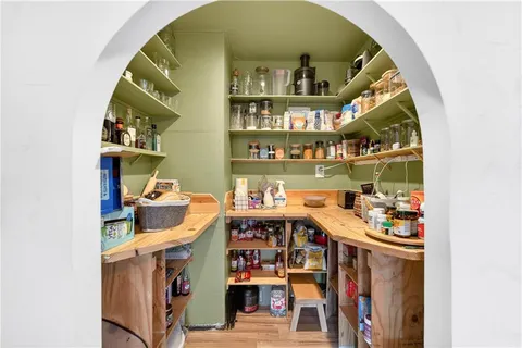 a living room with furniture a flat screen tv and a table