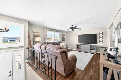 a bedroom with furniture a flat screen tv and a fireplace