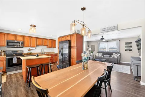 a dining room with a table chairs and a kitchen view