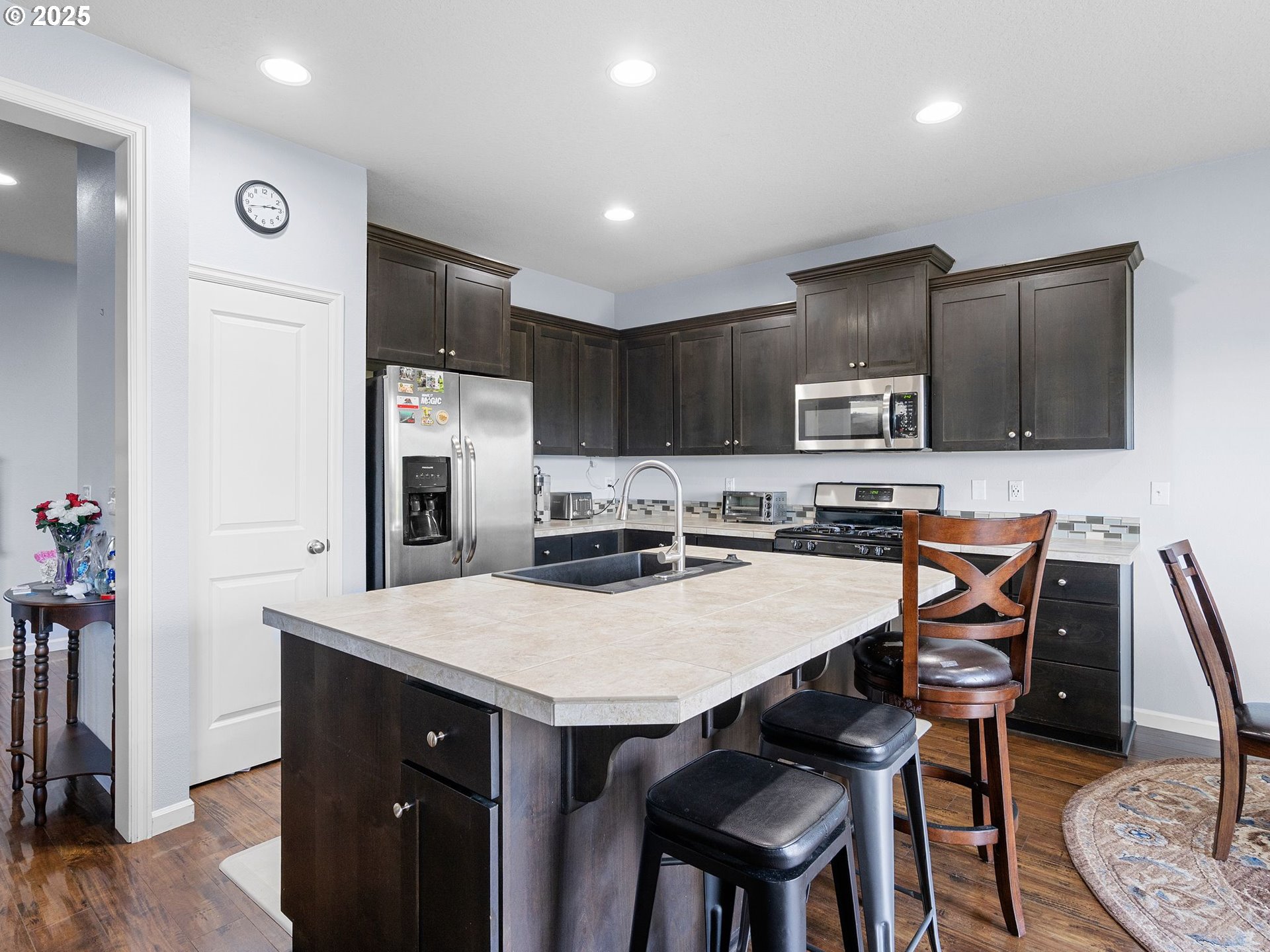 51350 Southwest Randstad Street Scappoose, OR 97056 - Photo 20 of 43 a kitchen with kitchen island a stove a table and chairs