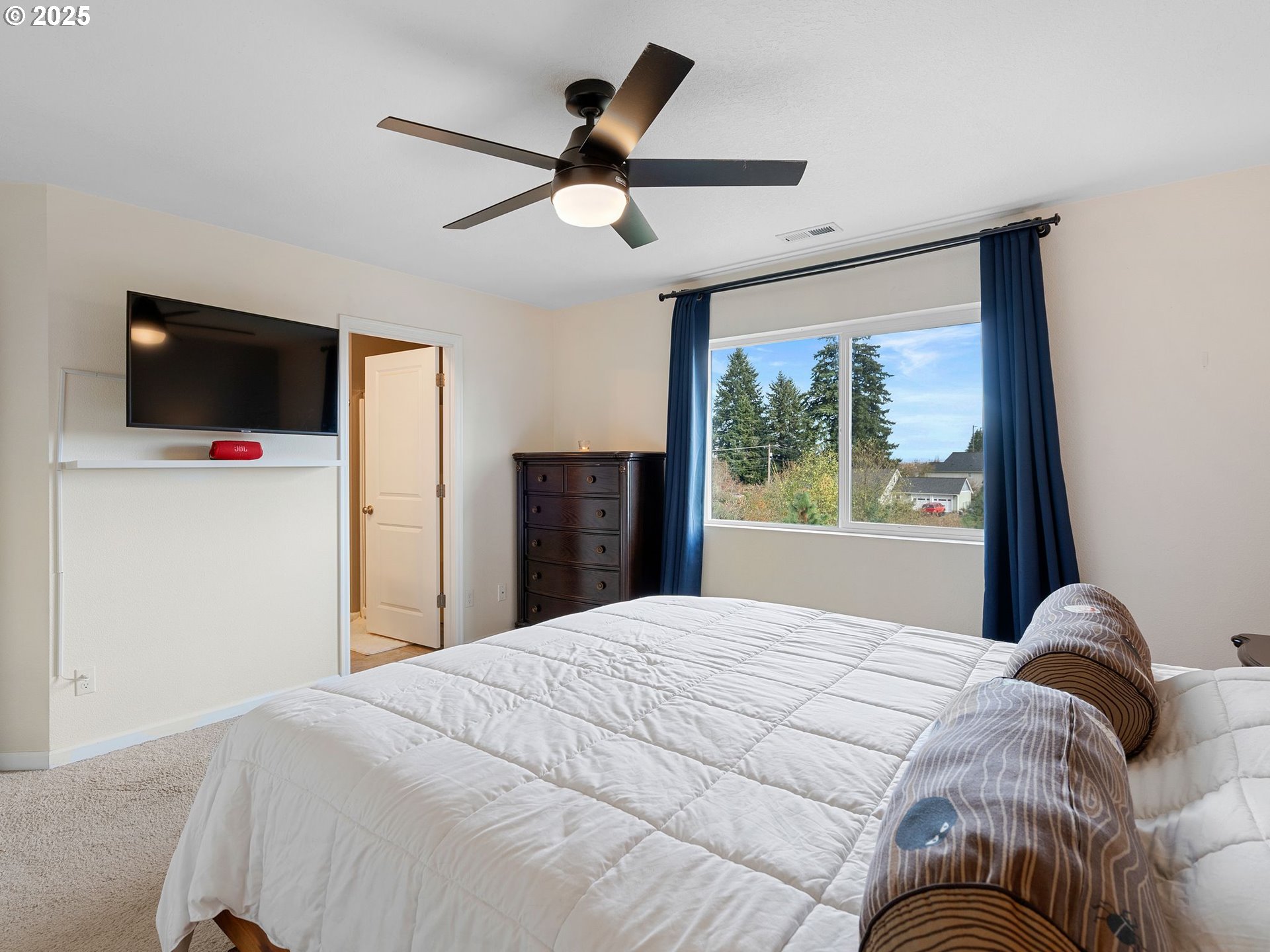 51350 Southwest Randstad Street Scappoose, OR 97056 - Photo 31 of 43 a bedroom with a bed and a flat screen tv