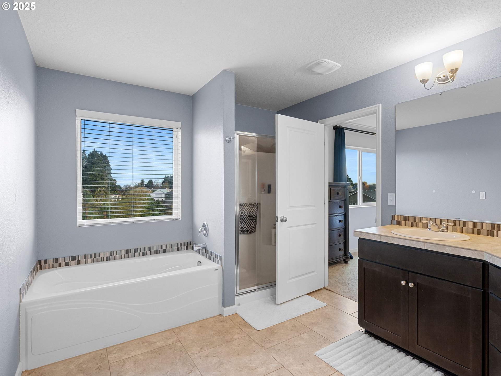 51350 Southwest Randstad Street Scappoose, OR 97056 - Photo 34 of 43 a bathroom with a tub a sink and a shower