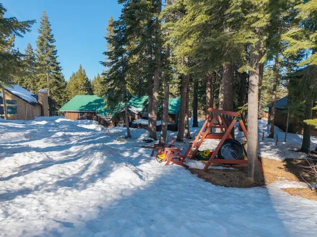 a view of a patio with table and chairs under an umbrella