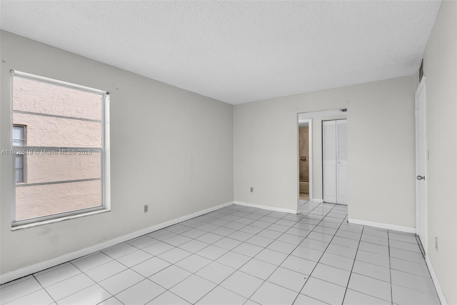 7345 West 4th Avenue, Unit 402 Hialeah, FL 33014 - Photo 16 of 22 a view of an empty room and window