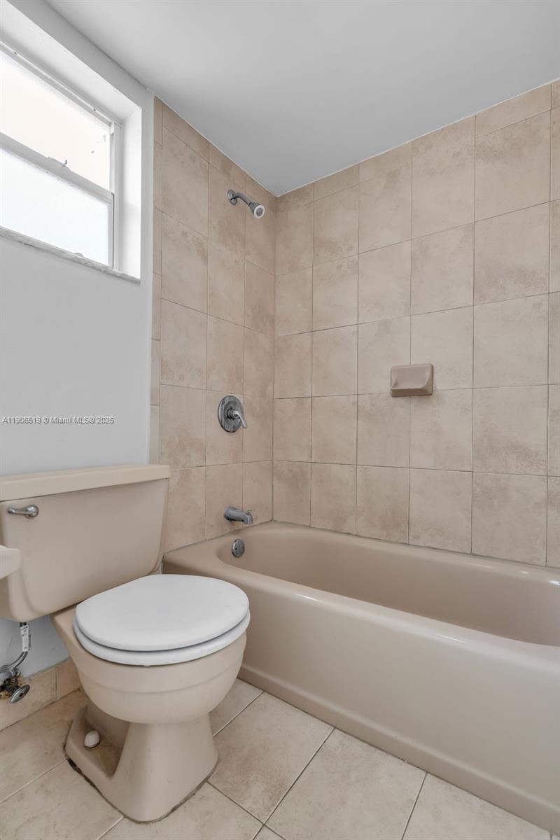 7345 West 4th Avenue, Unit 402 Hialeah, FL 33014 - Photo 18 of 22 a bathroom with a toilet and a bath tub