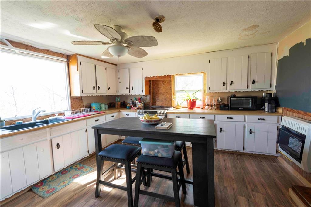 946 Hightower Loop Road Ranger, GA 30734 - Photo 11 of 22 a kitchen with stainless steel appliances granite countertop a table chairs sink refrigerator and cabinets