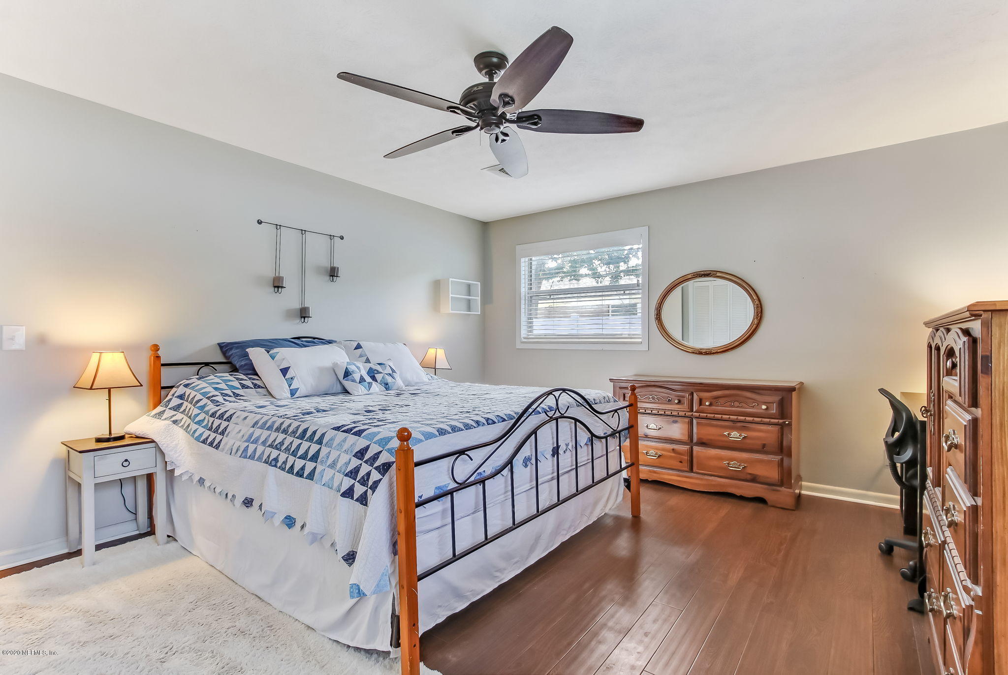 4006 Eunice Road Jacksonville, FL 32250 - Photo 20 of 30 a bedroom with a bed chandelier and a window